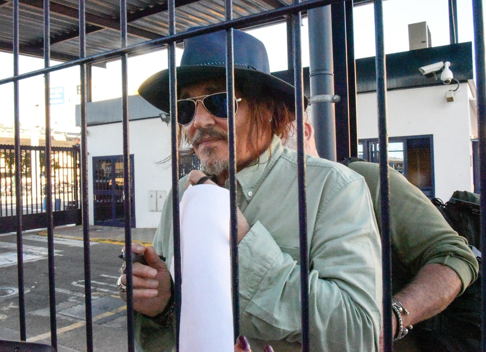 约翰尼·德普隔铁窗和影迷互动 圆圆啤酒肚藏不住